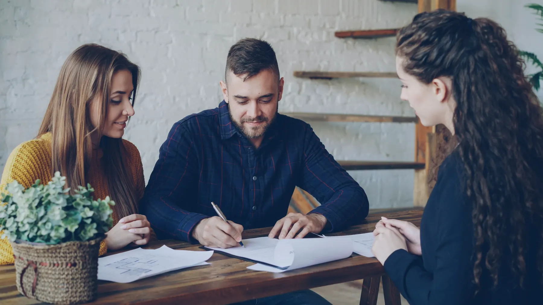 A couple reviewing paperwork with an advisor