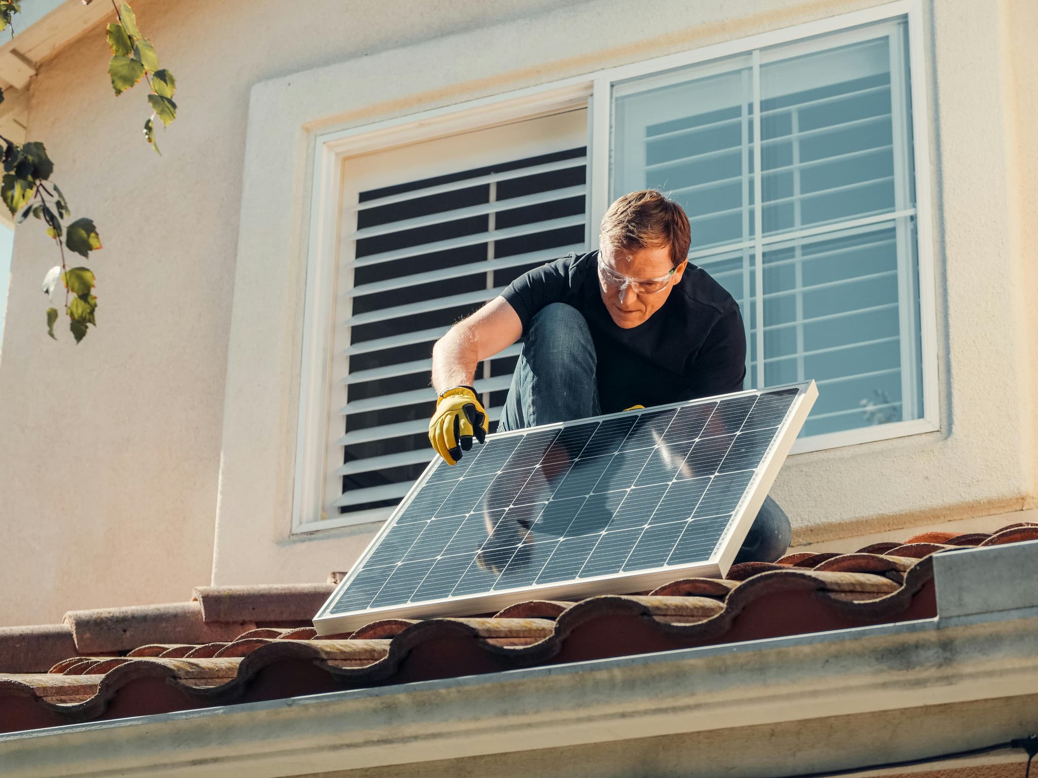 Installers mounting solar panels on a Florida tile roof with flashed attachment points